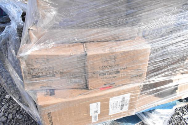 Plastic-wrapped pallet of boxes labeled Lancaster, containing cast iron table bases. Scratch and dent condition.