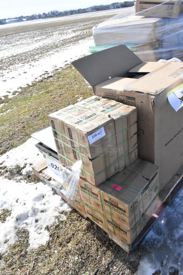 Four brand new items including a Southbend tray, dome lids, and a Pitco filter pan on a pallet. Boxes show storage wear.
