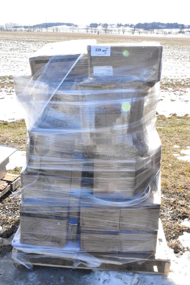 Pallet of 31 new scratch and dent items, including wine glasses, pizza pans, coupe plates, and wire shelf, wrapped in plastic.