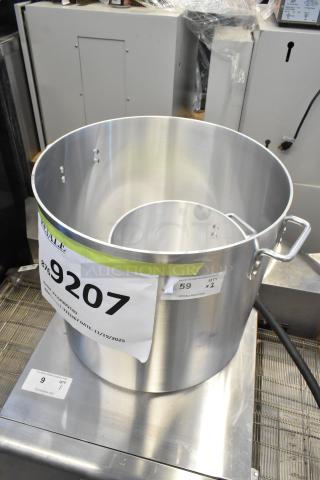 Brand new Choice 80 Qt. heavyweight aluminum stock pot, slight scratch and dent, with auction tags attached.