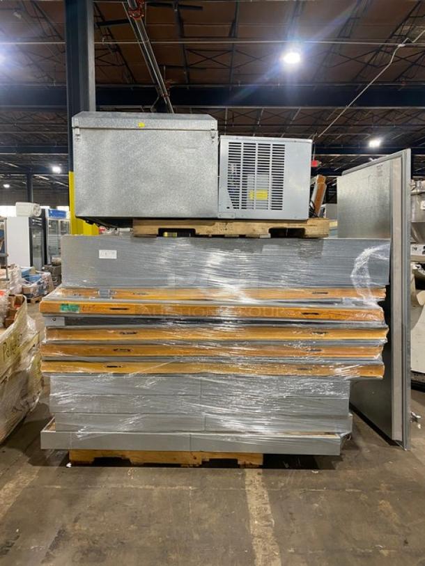 Industrial refrigeration unit on pallets, wrapped in plastic. Visible labels, no identifiable markings. Appears in used condition.