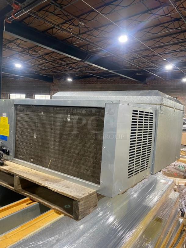 Industrial HVAC unit in gray metal, showing air vents and a coil. Appears gently used. Identifiable labels on side.