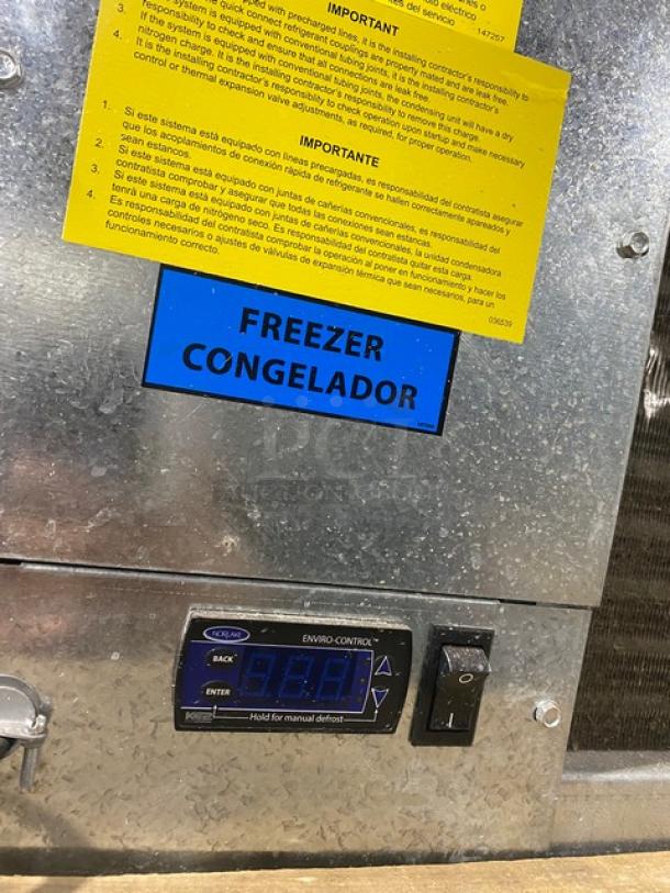 Commercial freezer unit with Enviro-Control digital display, manual defrost switch, and bilingual "FREEZER CONGELADOR" label.