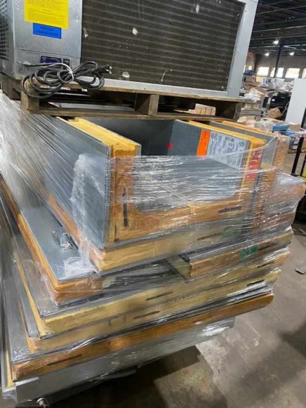 Stack of packaged HVAC duct sections with insulation, shrink-wrapped and palletized, visible manufacturer labels indicating specifications.