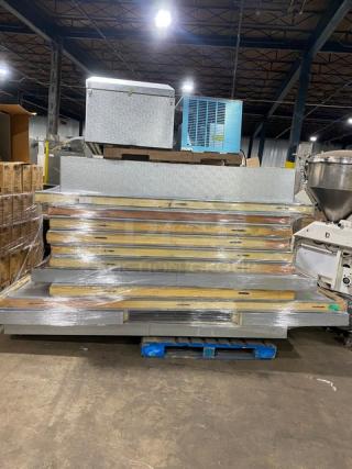 Stack of industrial metal shelving units on a pallet, wrapped in plastic. New condition, suitable for warehouse use.