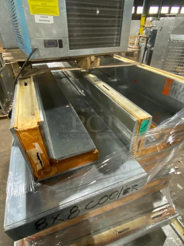 8x8 industrial cooler unit with visible wear, labeled "COOLER" and "ENTRADAS," indicating connections. Pallet-wrapped for auction.