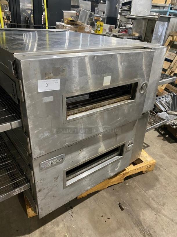 Commercial conveyor pizza oven, stainless steel, branded Lincoln. Used condition, minor surface wear, model details not visible.