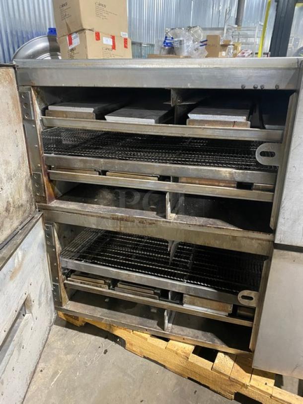 Commercial conveyor pizza oven, stainless steel, three decks, worn condition, ideal for high-volume food service operations.