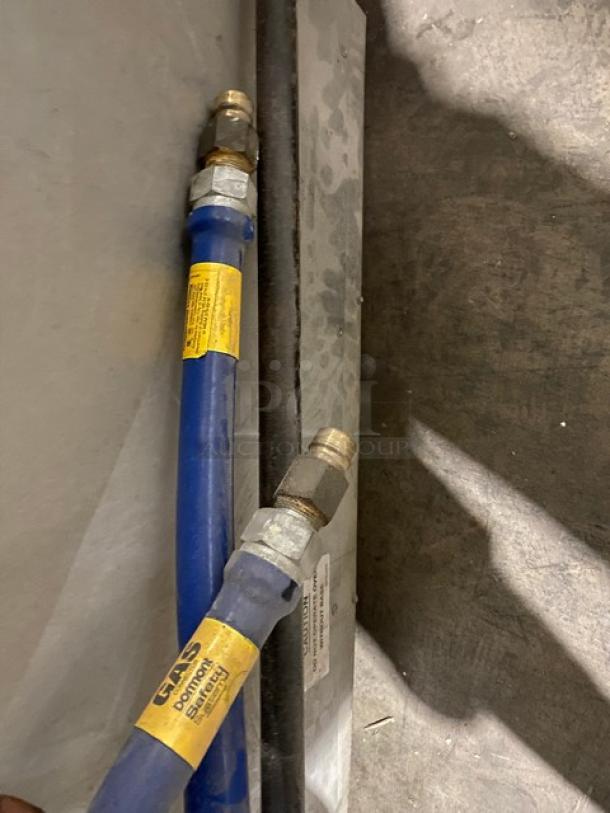 Two blue hydraulic hoses with metal fittings; tags indicate use for natural gas. In used but good condition.