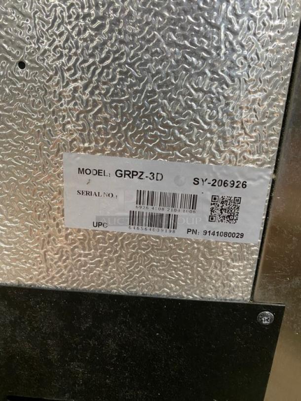 Metal appliance with model label reading "GRPZ-3D," serial number, QR code, and UPC. Silver textured surface.