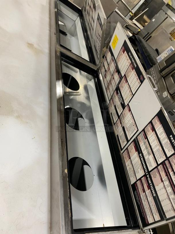 Commercial food prep station with stainless steel base and menu boards. Features circular cutouts for inserts. Good condition.