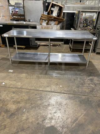 Stainless steel work table with lower shelf, in good condition. Ideal for industrial or commercial kitchens, sturdy and spacious.
