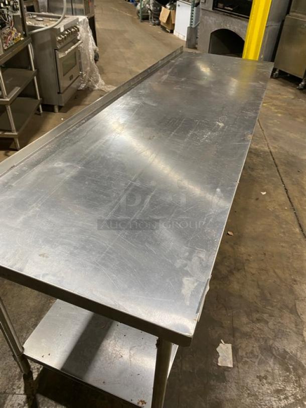 Stainless steel kitchen prep table, used condition with surface scratches, bottom shelf included, ideal for commercial use.