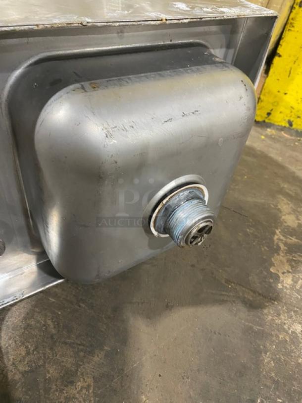 Industrial metal tank, square protrusion, visible threaded pipe fitting. Some surface wear, gray finish, used condition.