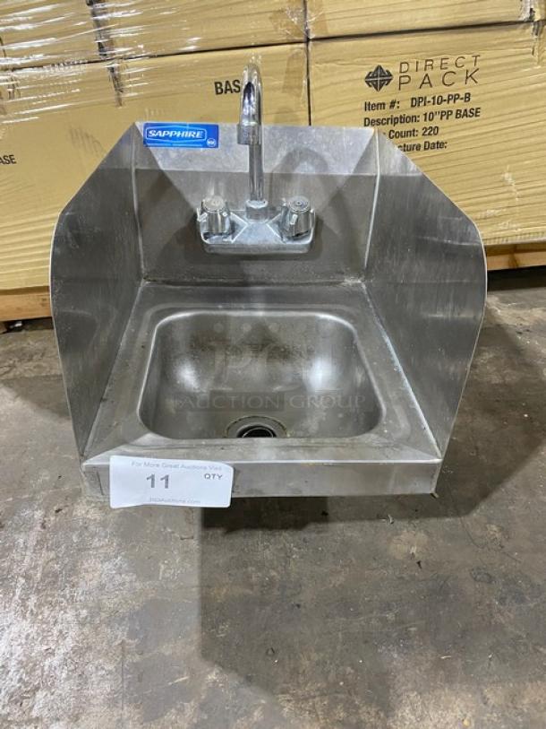 Stainless steel wall-mounted sink with faucet, brand "Sapphire," excellent condition, protective side splashes, suitable for commercial use.