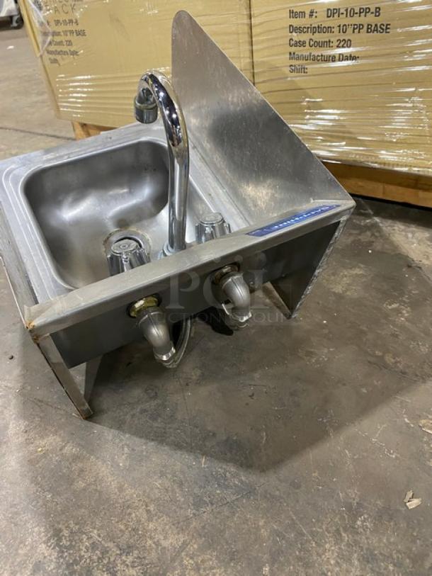 Stainless steel commercial sink with faucet and dual water connections, used condition, item number label visible.