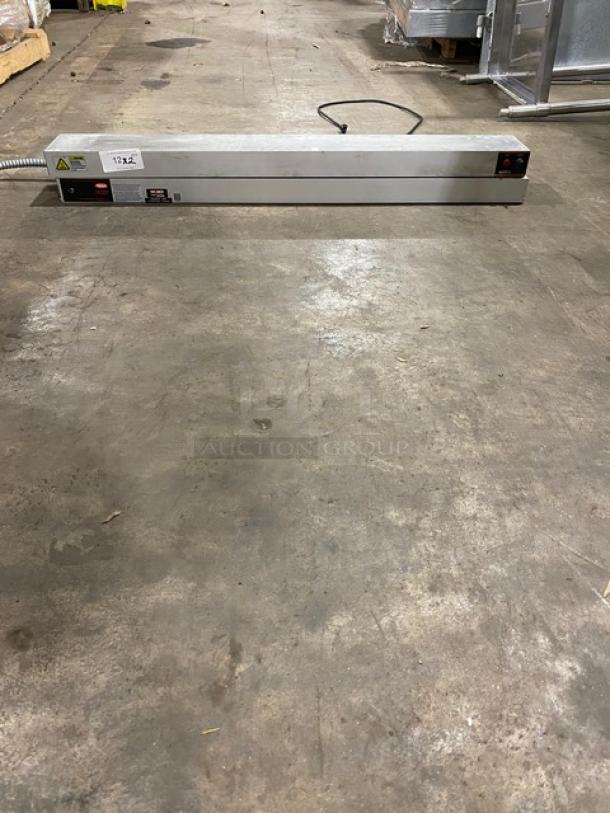 Industrial heat sealer with metal casing, good condition, power switch and cable visible, labeled "122."