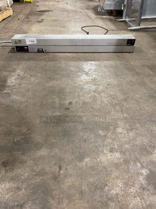 Industrial heat sealer with metal casing, good condition, power switch and cable visible, labeled "122."