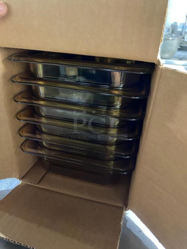 Stack of glass baking dishes in a cardboard box, brand new condition.