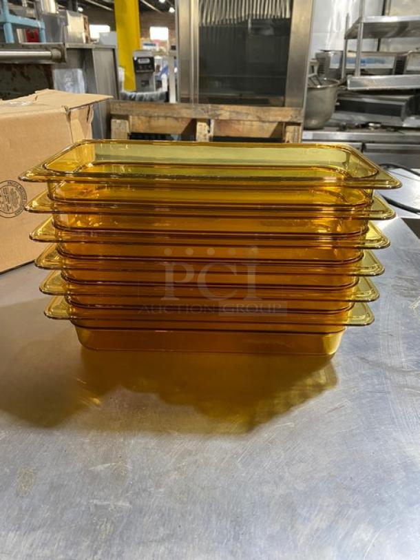Stack of vintage amber glass serving trays, rectangular, excellent condition, no visible chips, kitchen in background.