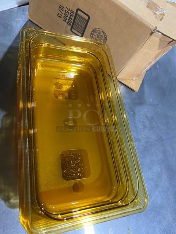 Yellow food storage container with lids, made of transparent plastic, shown near a cardboard box. Ideal for kitchen use.