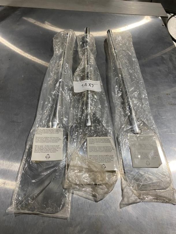 Three stainless steel pizza peels in plastic wrapping with labels, new condition; labeled size of 14 x 37 inches.
