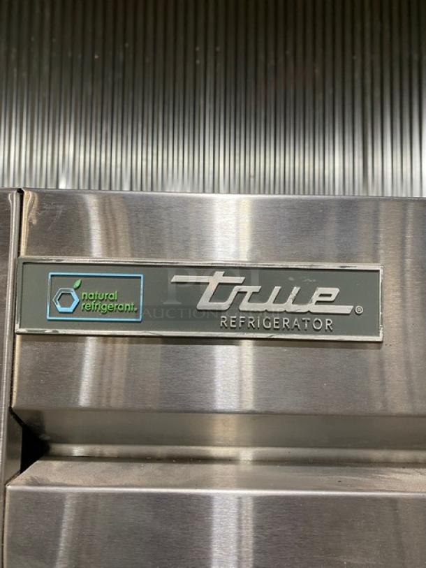 Stainless steel True refrigerator featuring a natural refrigerant label.