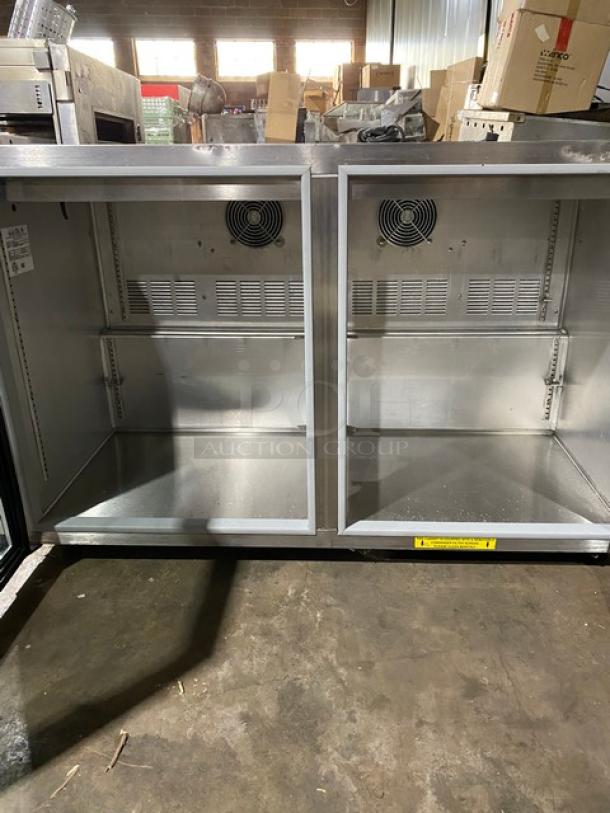 Commercial stainless steel double-door refrigerator unit, open and empty, with interior fans. Used condition.