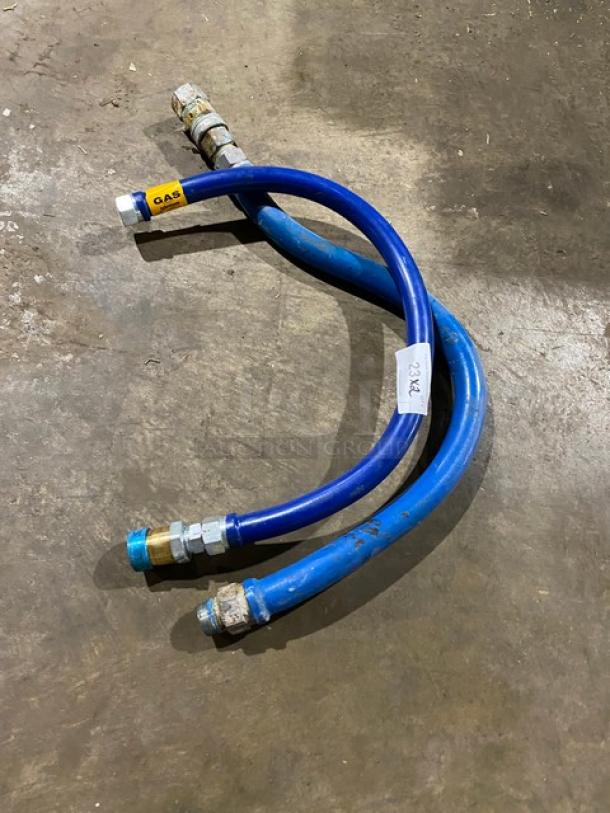 Two blue gas hoses with metal connectors, labeled "GAS" and "2042." Slightly used condition.