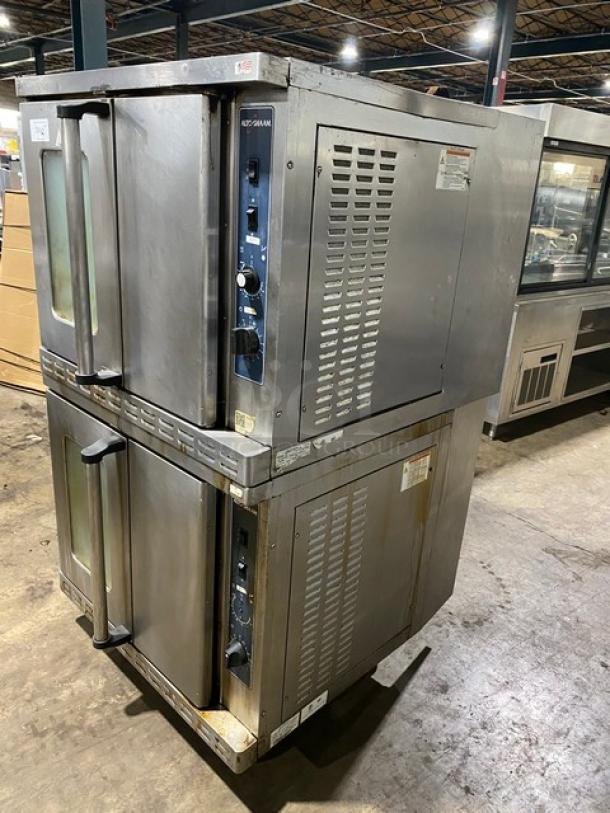 Double-stacked commercial convection ovens, stainless steel, used condition, visible control knobs, manufacturer labels intact.