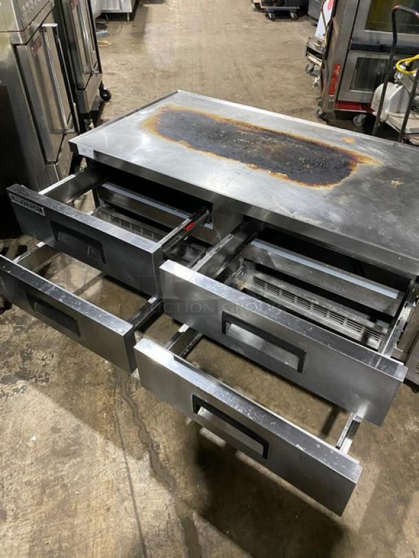 Stainless steel commercial kitchen equipment with multiple sliding drawers, visible surface wear, branded "Randell."