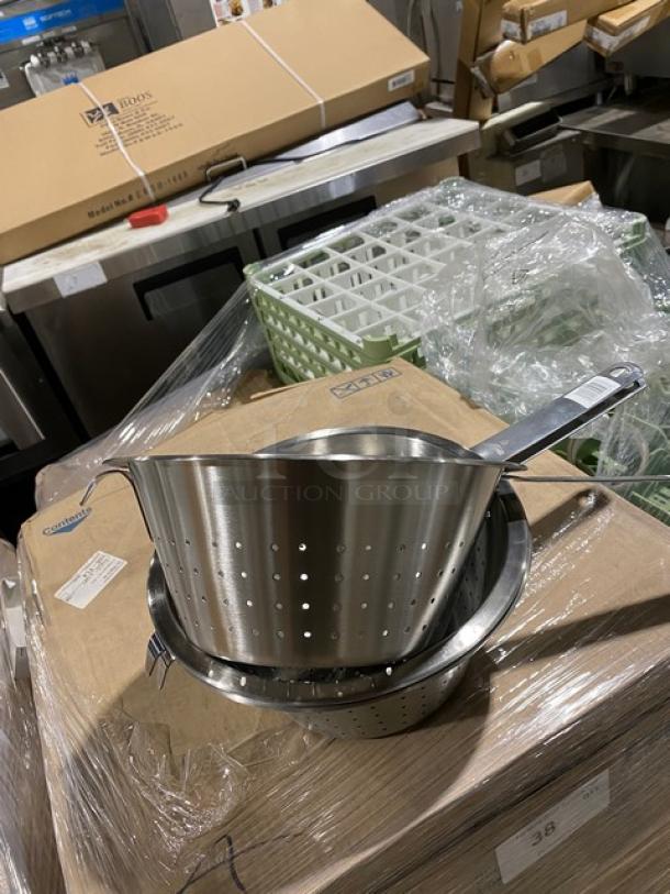 Stainless steel colanders with handles, stacked on boxes, new condition.