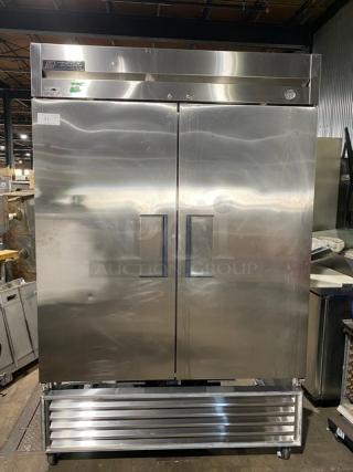 Commercial True double-door stainless steel refrigerator, model T-49, with temperature gauge; minor surface wear.