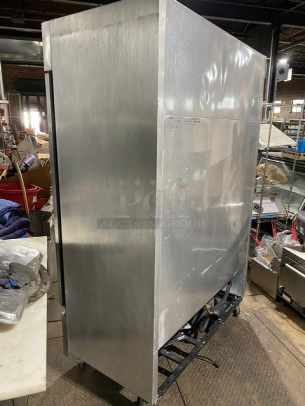 Commercial stainless steel refrigerator, excellent condition, industrial size, side view. No visible labels or markings.