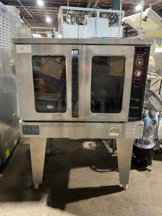 Commercial double convection oven with stainless steel exterior, two glass doors, control panel with dials on the right. Model label visible.
