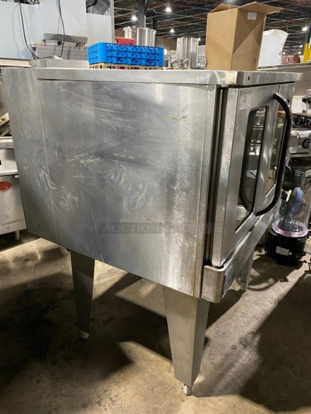 Commercial stainless steel convection oven, scratched surface, dual handles, ideal for restaurant use, good condition.