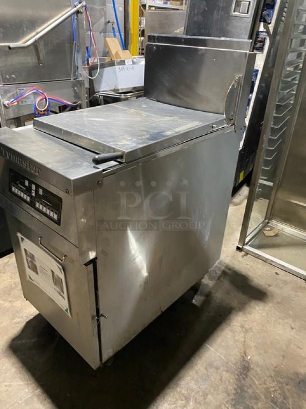 Stainless steel Frymaster commercial fryer, model with digital controls, used condition with visible wear. Manual attached.