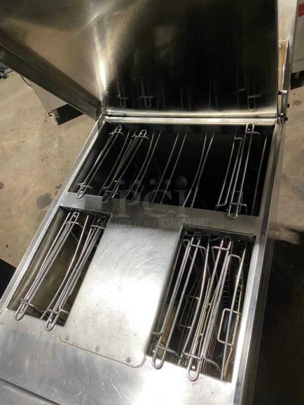 Industrial stainless steel fryer basket holder with open top, showcasing multiple compartments. In good condition, made for commercial kitchens.