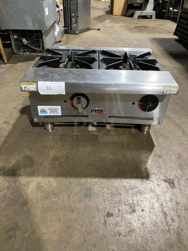 Commercial stainless steel two-burner countertop stove, model APW Wyott, in good condition with visible control knobs and labels.