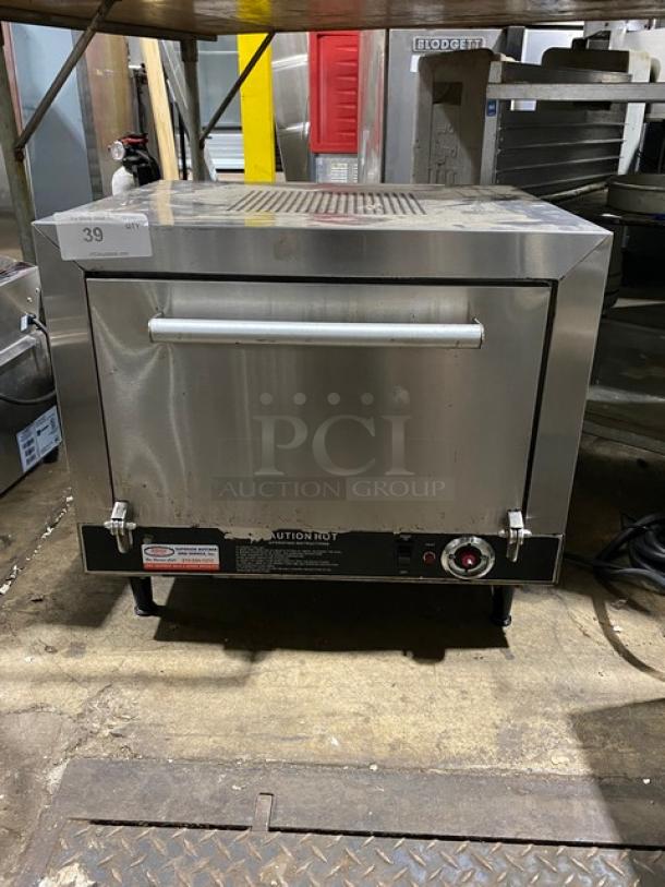 Commercial countertop oven, stainless steel, front control knob, visible wear, caution label. Lot number 39.