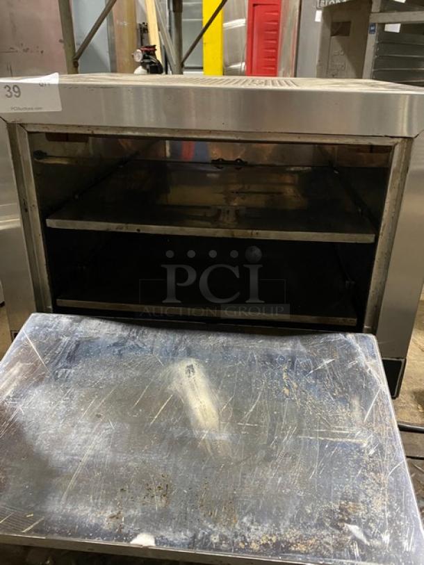 Commercial stainless steel oven with open door, featuring two shelves. Visible wear on interior and door. Auction tag: Lot 39.