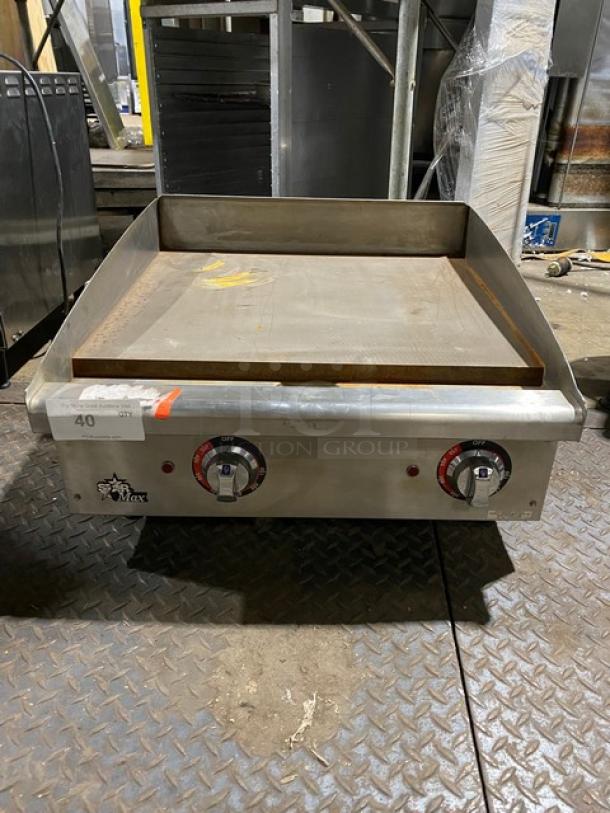Commercial flat top griddle with dual controls, stainless steel, used condition, showing manufacturer logo and label "40 OT".