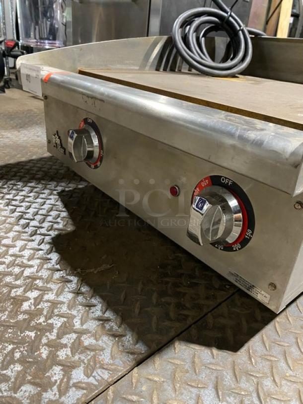 Commercial stainless steel griddle with dual temperature control knobs, red indicator light, and visible cord; good condition.