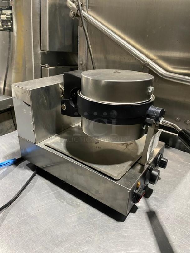 Commercial waffle maker, stainless steel, used condition, features rotary function and temperature controls, includes attached power cord.