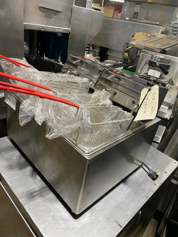 Commercial double deep fryer with red-handled baskets, stainless steel finish, power cord, price tag indicating $10.00.