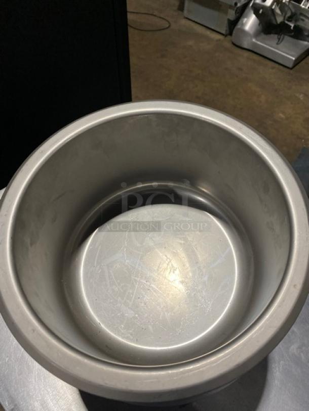 Stainless steel bowl with visible scratches, cylindrical shape, used condition, suitable for commercial kitchen use.