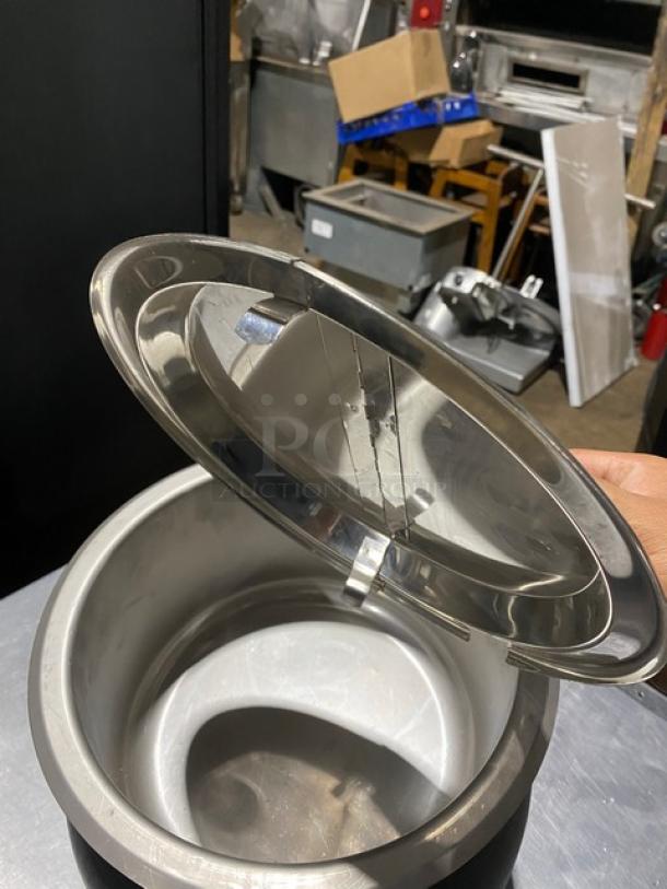 Stainless steel soup kettle with hinged lid, good condition, few scratches, ideal for food service, visible scuff marks.