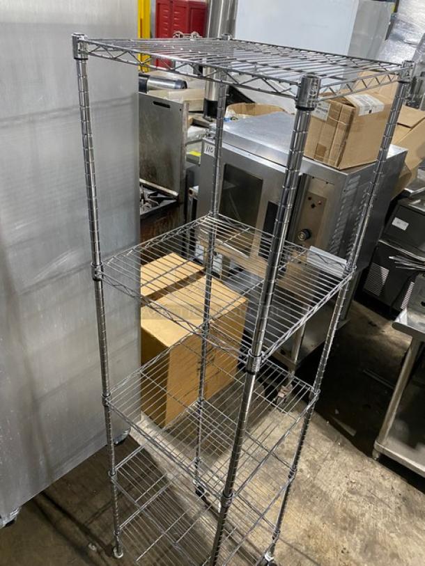 Metal wire shelving unit, five-tier, on wheels, used condition, adjustable shelves; ideal for industrial or pantry storage.