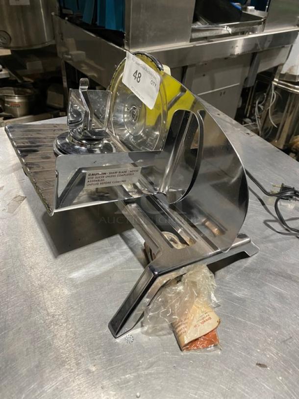 Commercial deli meat slicer, stainless steel, includes blade guard, used condition, item number 48.