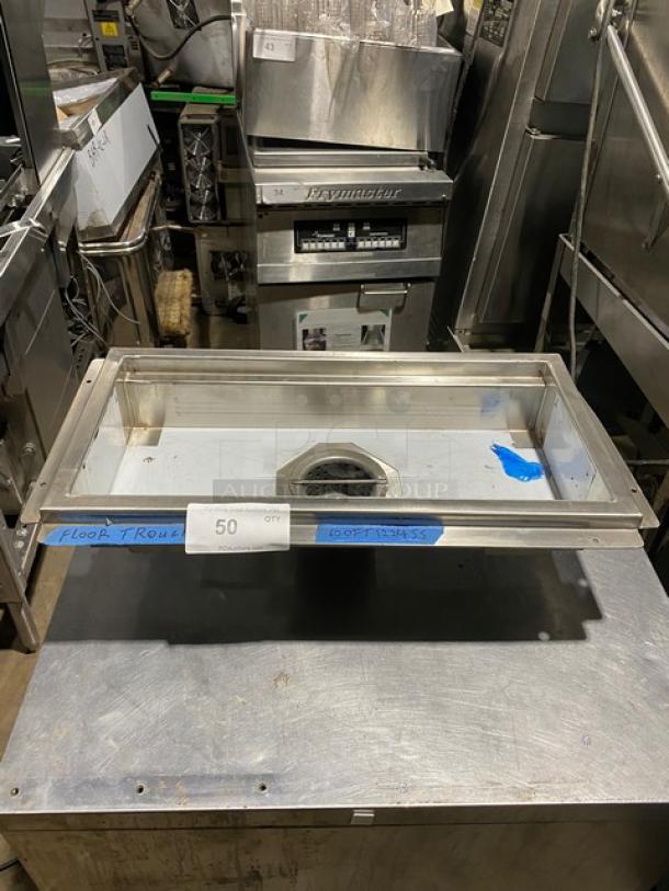 Stainless steel floor trough with drain, used condition, labeled "50 QTY" and "FLOOR TROUGHS," measures approximately 24"x16".
